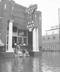 1951 era, photo of front of Kansas State Bank in flood with men fishing off front steps